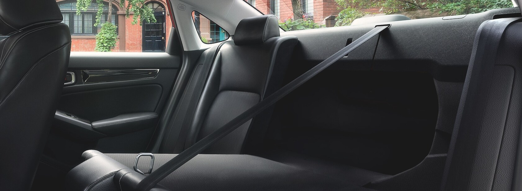 A view of the rear split-back seat with one seatback pulled forward allowing access to the trunk of the 2022 Honda Civic