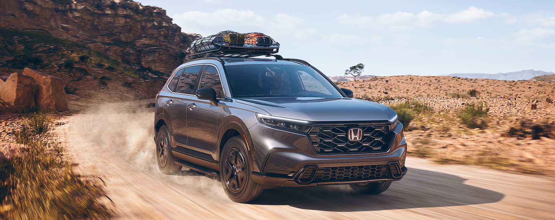 2025 Honda CR-V Hybrid driving in a desert.