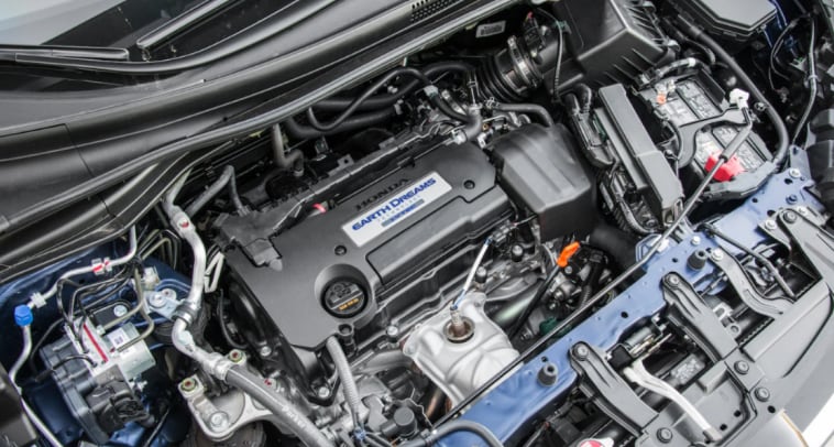 A view under the hood of the new 2023 Honda CR-V showing the engine and assorted wires