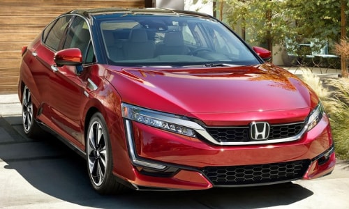 2020 Honda Clarity parked suburban driveway hard wood garage door green grass