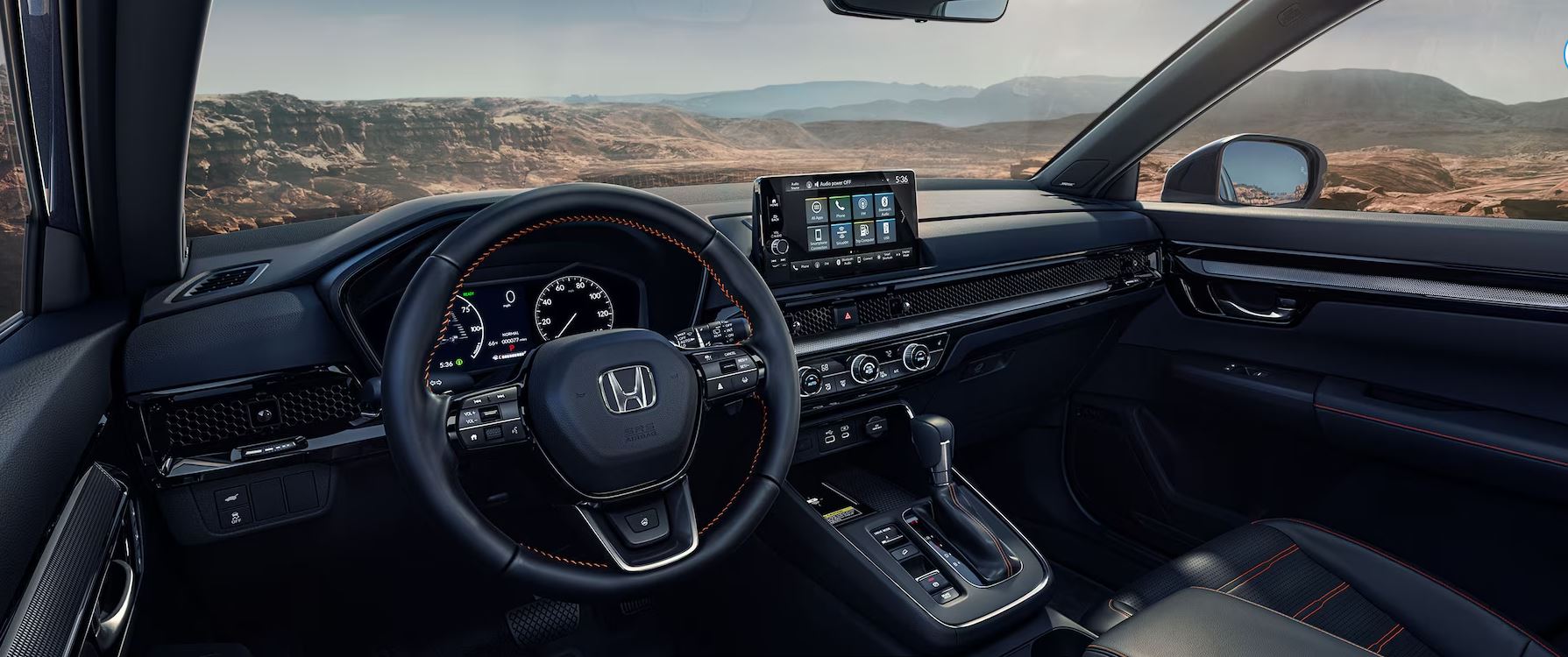 Interior view of the Honda CRV facing the dashboard and control center.