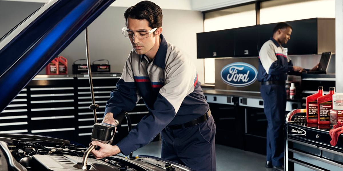 Ford service center mechanic working on vehicle Ayden, NC