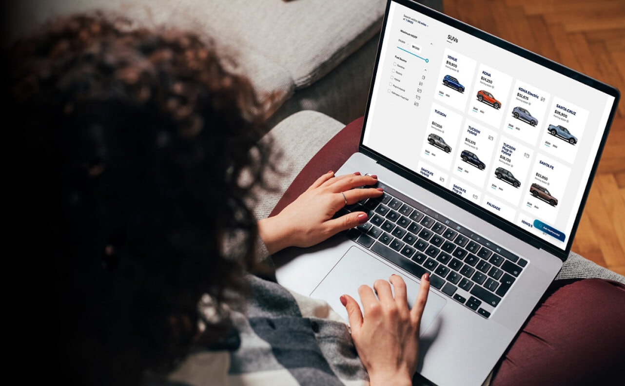 A woman on a laptop shopping for Hyundai vehicles.
