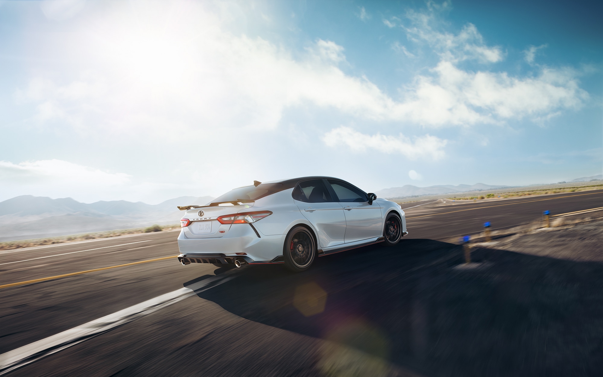 A 2020 White Toyota Camry takes a quick turn on a track