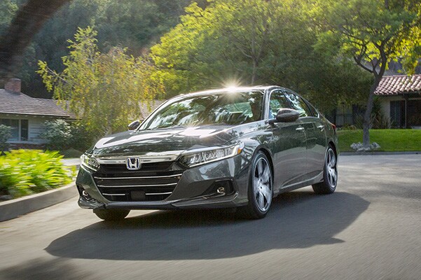 dark grey used Honda Accord sedan driving through a neighborhood