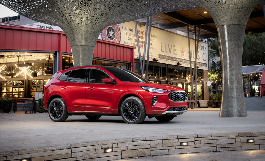 red Ford Escape parked in front of a live music venue