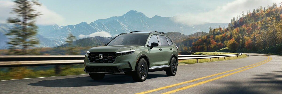 Green 2026 Honda CR-V Hybrid Driving on a Fall Day