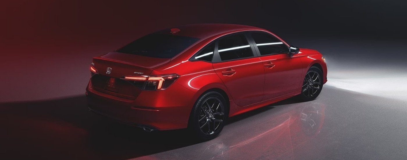 A red 2023 Honda Civic Sport is shown after leaving a used car dealer near Dearborn.