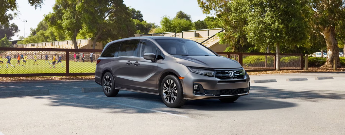 Silver 2026 Honda Odyssey parked by a field