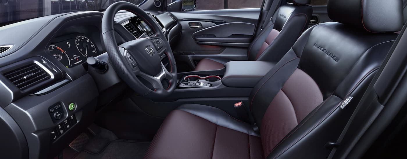 Black and maroon leather seating in a 2025 Honda Ridgeline Black Edition