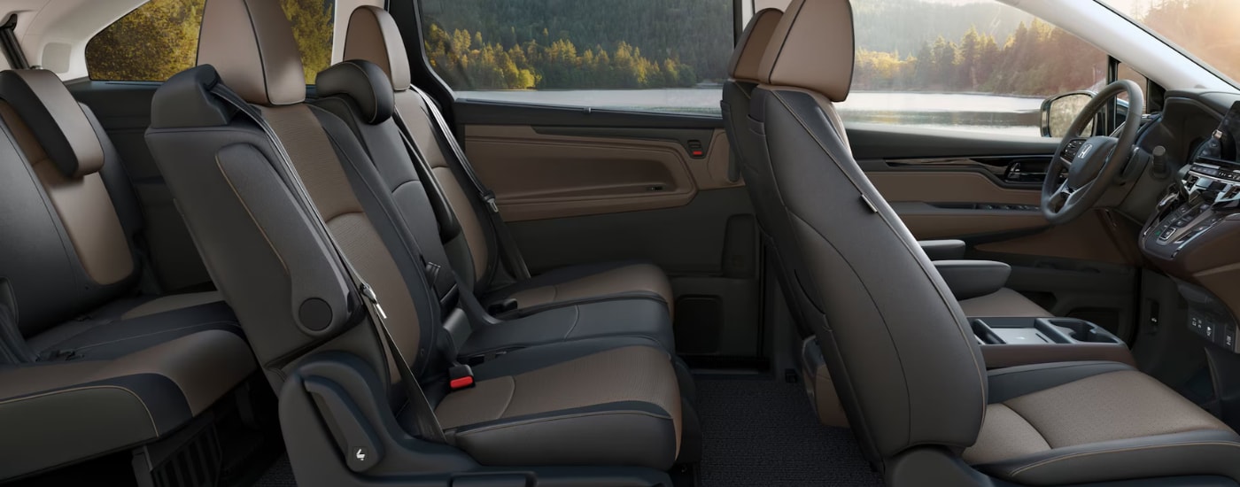 Brown and black interior of a 2026 Honda Odyssey showing all three rows