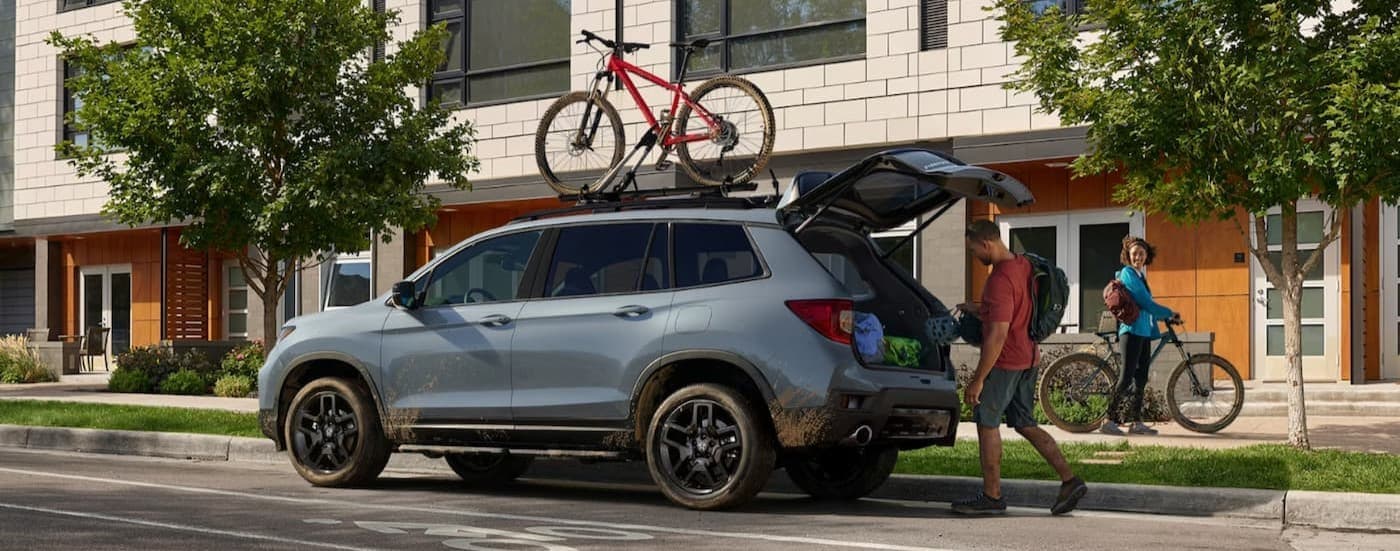 A 2024 Honda Passport parked near a house.