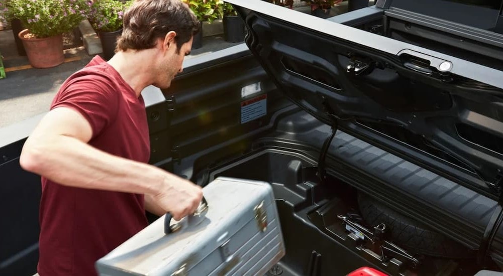 Under the bed storage of a black 2025 Honda Ridgeline for sale.