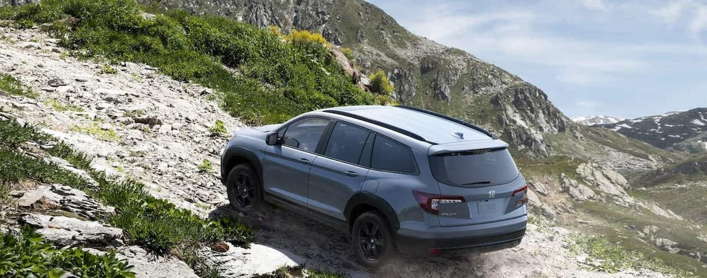 A gray 2022 Honda Pilot TrailSport driving off-road.