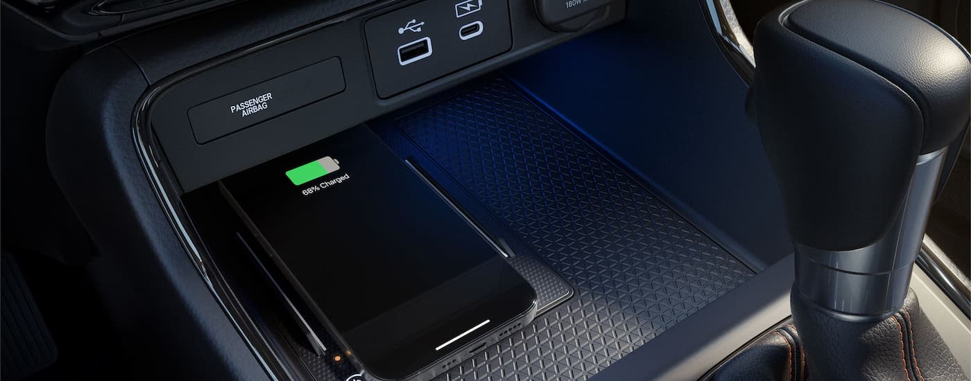 Phone in the center console charging pocket of a 2026 Honda CR-V