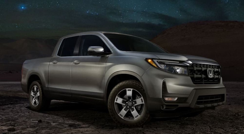 A silver 2025 Honda Ridgeline RTL for sale under a starry sky.