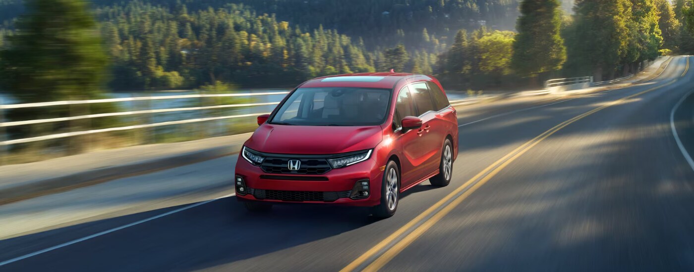 Red 2026 Honda Odyssey for sale on a test drive