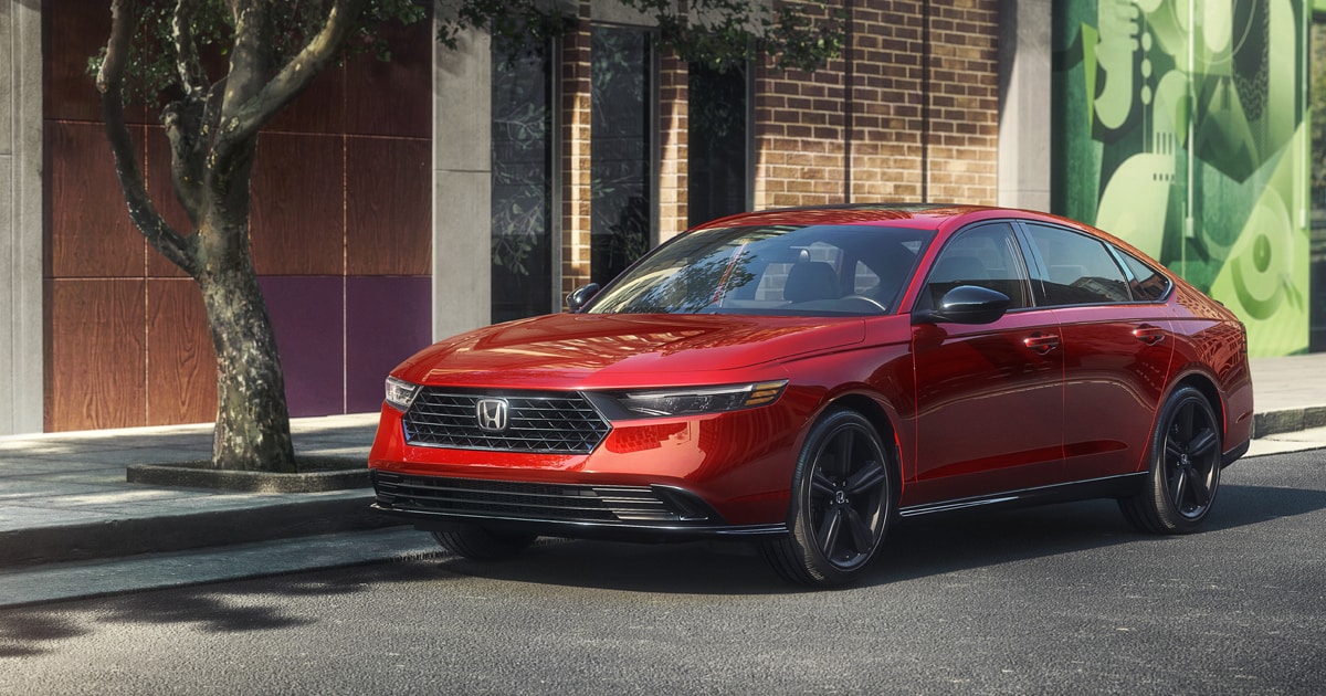 2024 Honda Accord in radiant red metallic color parked on a city street.