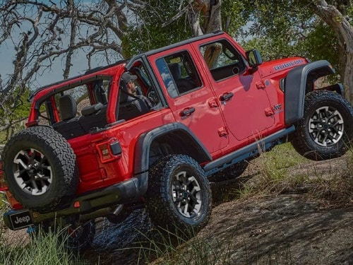 2025 Jeep Wrangler driving up hilly terrain