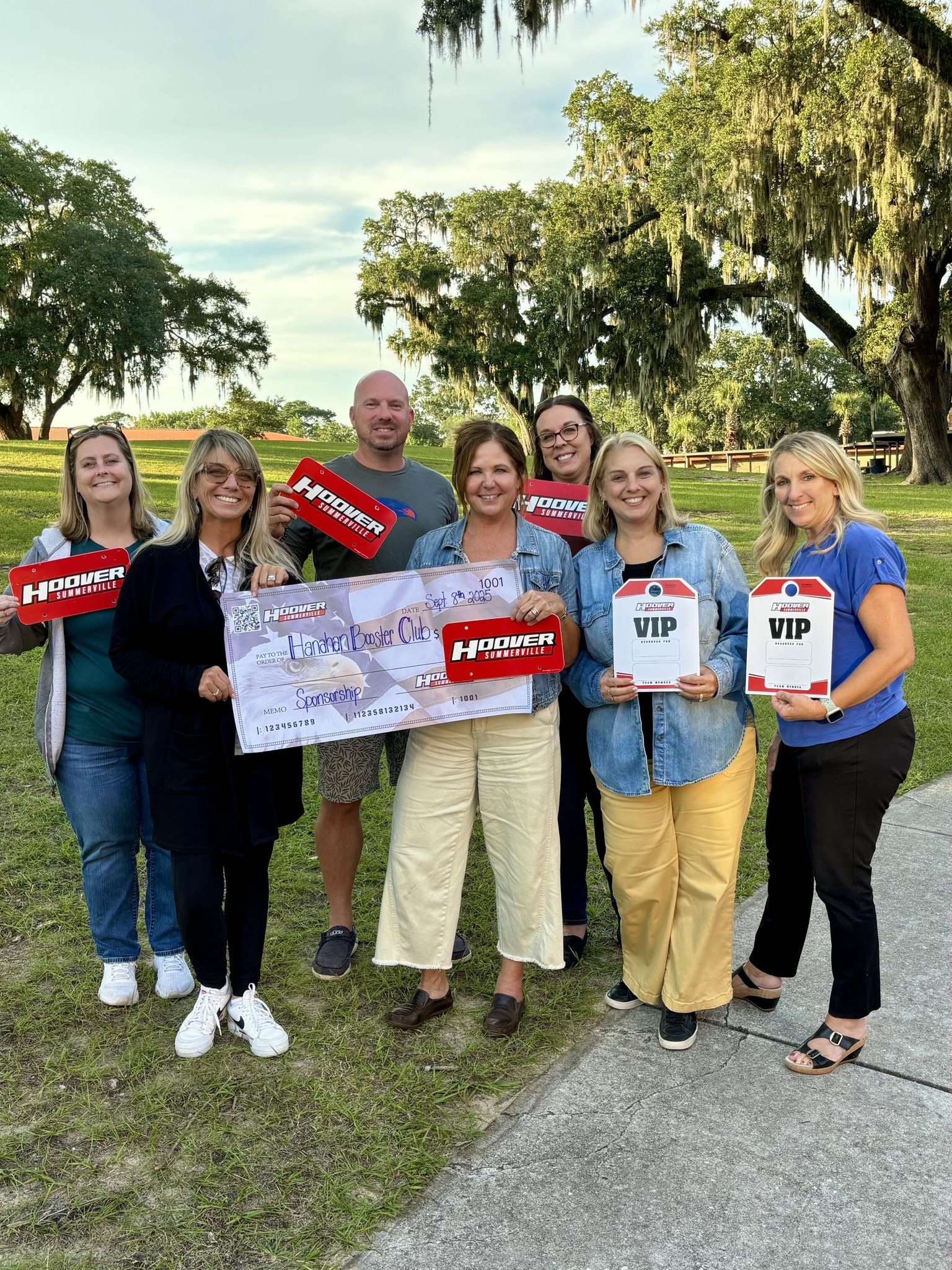 Hoover team with Hanahan High sponsorship check