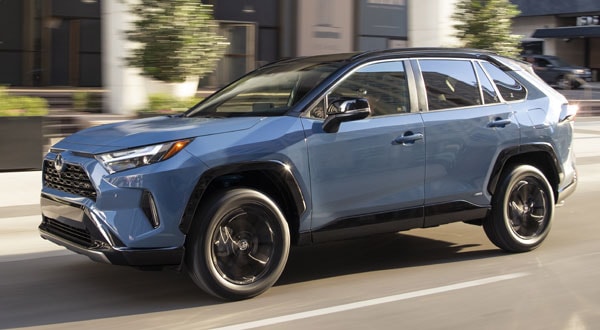 Blue 2022 Toyota RAV4 XSE Driving Down a City Street