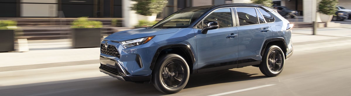 Blue 2022 Toyota RAV4 XSE Driving Down a City Street