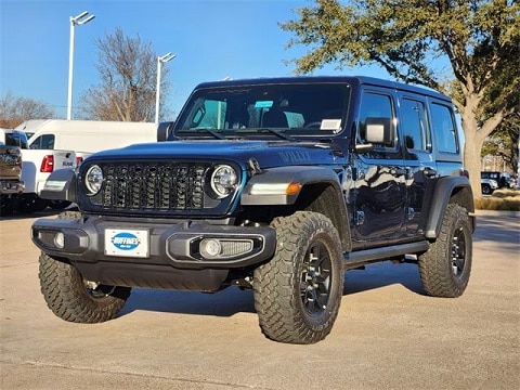 black 2025 Jeep Wrangler SUV parked at the Huffines CDJR Plano dealership in Plano, TX