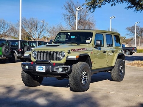 tan 2026 Jeep Wrangler SUV parked at the Huffines CDJR Plano dealership in Plano, TX