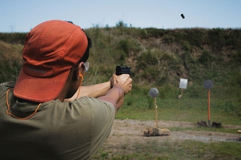 person shooting a gun at a gun range in Plano, TX