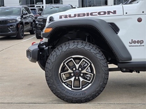 white 2025 Jeep Wrangler Rubicon SUV parked at the Huffines CDJR Plano dealership in Plano, TX