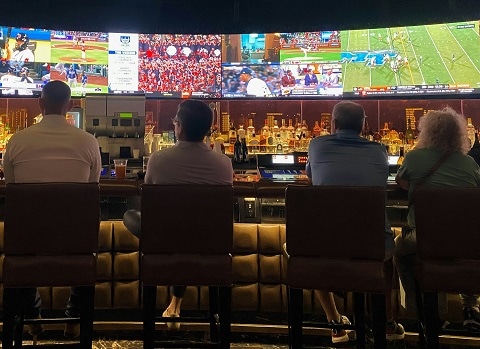 people watching sports at a sports bar in Plano, TX