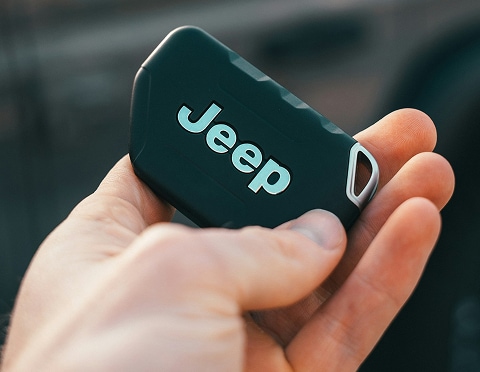 a person holding a Jeep car keyfob