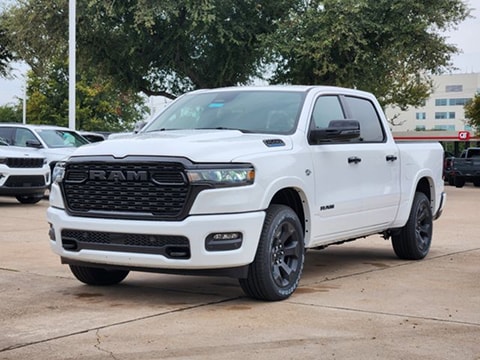 white 2026 RAM 1500 truck parked at the Huffines CDJR Plano dealership in Plano, TX