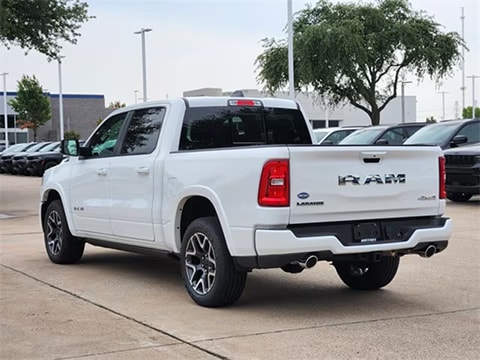white 2026 RAM 1500 truck parked at the Huffines CDJR Plano dealership in Plano, TX