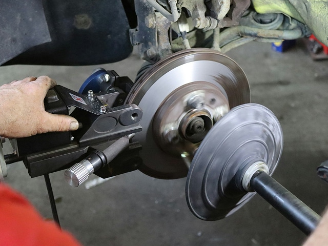 a brake rotor getting resurfaced at the Huffines CDJR Plano service center in Plano, TX