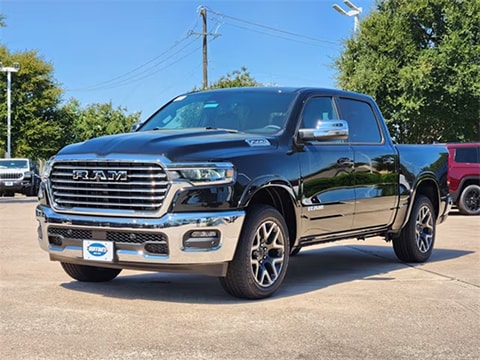 black 2026 RAM 1500 truck parked at the Huffines CDJR Plano dealership in Plano, TX