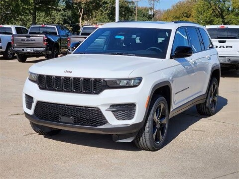 white 2024 Jeep grand cherokee SUV parked at the Huffines CDJR Plano dealership in plano, tx