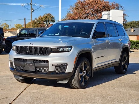 grey 2025 Jeep Grand Cherokee SUV parked at the Huffines CDJR Plano dealership in Plano, TX