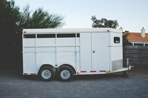 an unhitched trailer parked on the side of the road