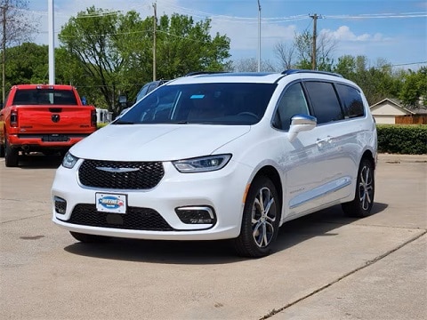 white 2024 chrysler pacifica minivan parked outside of the Huffines CDJR Plano dealership in plano, tx