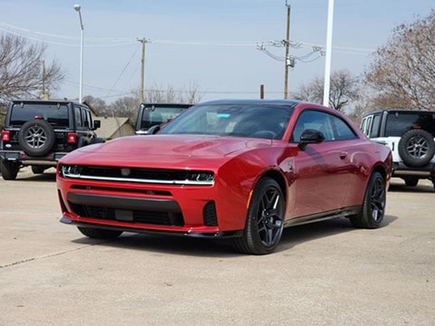 red 2026 Dodge Charger Scat Pack 2 door sedan parked at the Huffines CDJR Plano dealership in Plano, TX