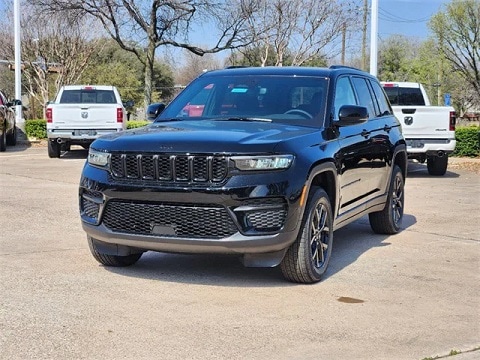 black 2024 Jeep grand cherokee SUV parked at the Huffines CDJR Plano dealership in Plano, TX