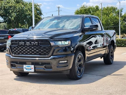 black 2025 RAM 1500 truck parked at the Huffines CDJR Plano dealership in Plano, TX