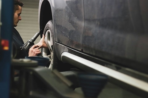 mechanic working on a car at the Huffines CDJR Plano service center in Plano, TX
