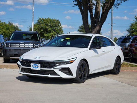 white 2026 Hyundai Elantra sedan parked at the Huffines Hyundai Plano dealership in Plano, TX