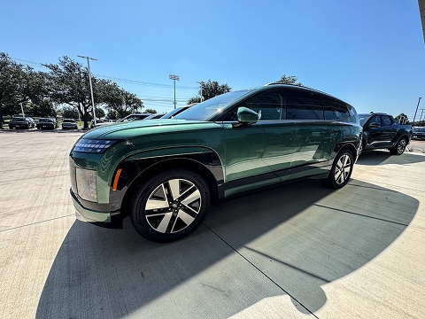 green 2026 Hyundai palisade SUV parked at the Huffines Hyundai Plano dealership in Plano, TX