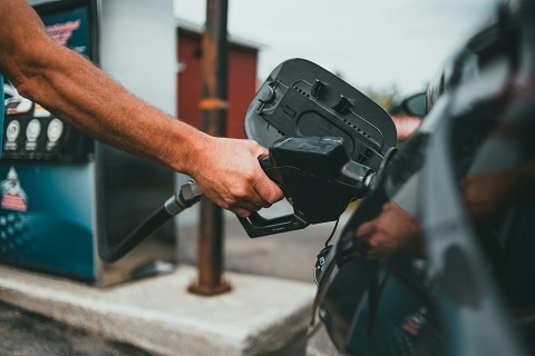 person filling their car up with gasoline