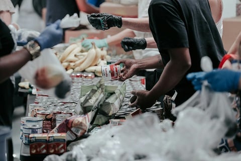people volunteering and handing out food at a food bank in plano, tx