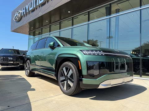 green hyundai ioniq 9 electric SUV parked at the Huffines Hyundai Plano dealership in Plano, TX