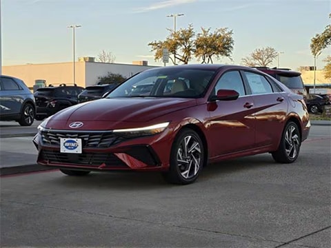 red 2026 Hyundai Elantra sedan parked at the Huffines Hyundai Plano dealership in Plano, TX